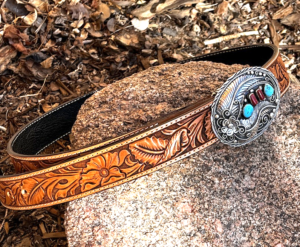 Hand carved leather belt with floral design and silver and turquoise buckle