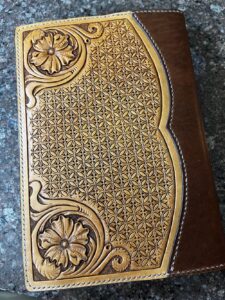 Back cover of a leather notebook cover with floral caring design and geometric stamping