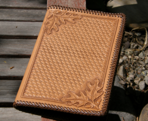 Hand Carved Leather Notebook with oak leaf designs in the corners.